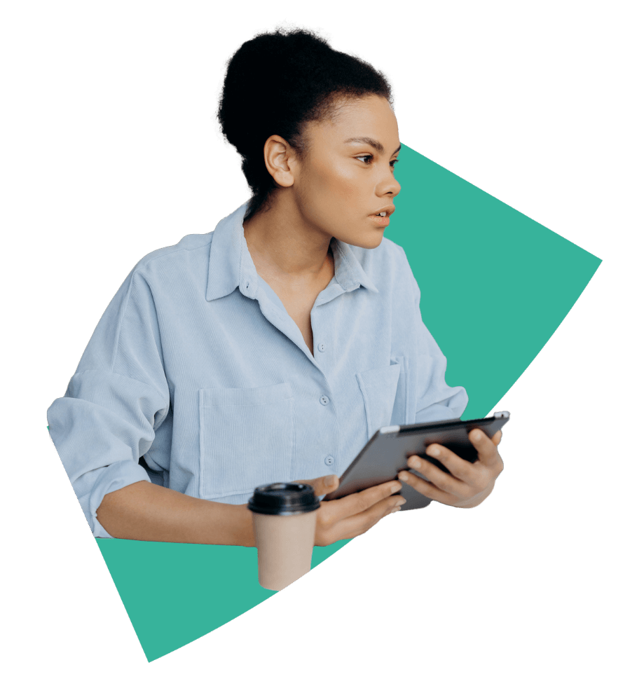 A woman holding a tablet and a coffee